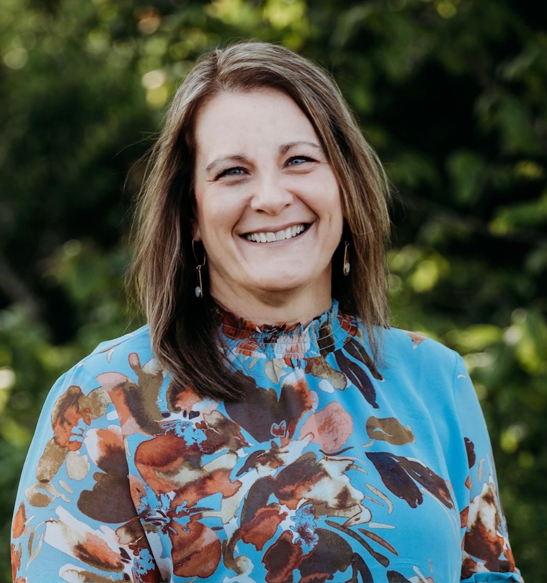 Yvette Valentin, Executive Director of United Way of Cecil County, smiling outdoors in a blue floral blouse.