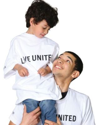 2 United Way persons, two Caucasian colored boys with Brown hair and brown eyes with white T-shirts with wording that says Live United in black uppercase lettering. Boy has Blue Jeans on.